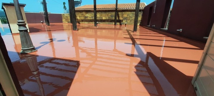 Terraço acabado a vermelho, sob a pérgula, pronto a pisar